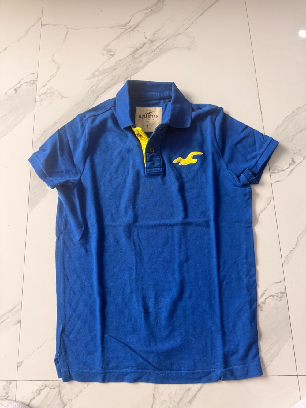 Hollister Men's Cobalt Blue Polo with Yellow Logo Accent